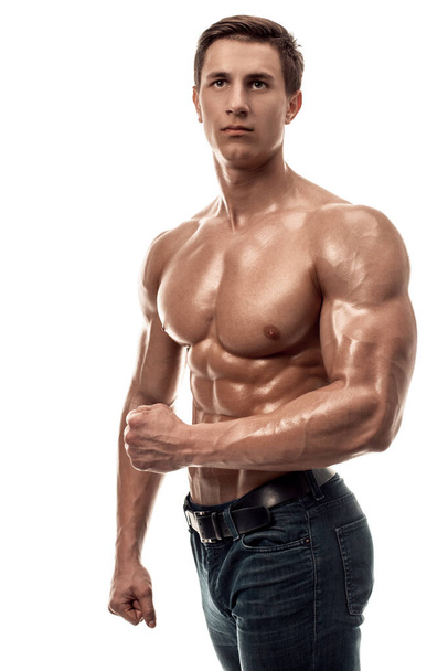Muscular handsome young man with naked torso. Isolated on white background. Studio shot on white background - Valokuva, kuva