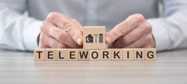 Wooden blocks with symbol of teleworking concept - Photo, image