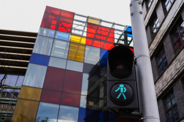 Traffic light near blurred building on street in Wroclaw - Photo, Image