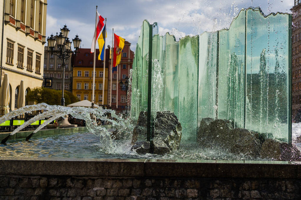 WROCLAW, POLAND - APRIL 18, 2022: Fountain on urban street at daytime  - Zdjęcie, obraz