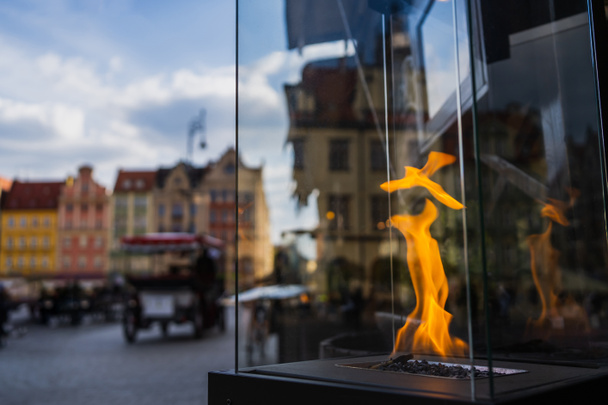 Fire in transparent box on urban street in Wroclaw - Fotoğraf, Görsel