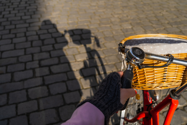 Cropped view of woman cycling on urban street in Wroclaw - Fotoğraf, Görsel