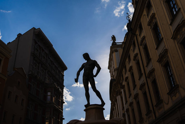WROCLAW, POLAND - APRIL 18, 2022: Silhouette on Fencer Fountain with sky at background - 写真・画像