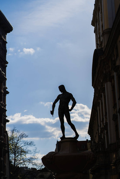 WROCLAW, POLAND - APRIL 18, 2022: Silhouette of statuette on Fencer Fountain on urban street  - 写真・画像