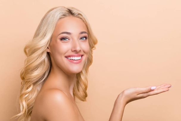 Photo of good mood adorable girl promote skincare routine product brand ambassador isolated on beige color background. - Foto, Imagem