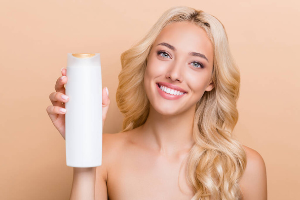 Close-up photo of amazing positive lady promote hair care routine shampoo conditioner isolated on beige color background. - Fotoğraf, Görsel