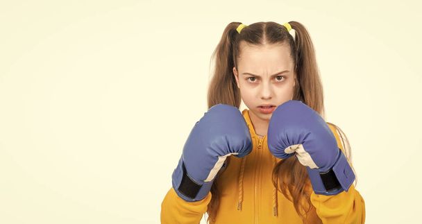 she will fight. concentrated kid punching. fist to fight. teen girl in boxing gloves. angry attack. child boxer isolated on white background. sport success. active and healthy childhood. knockout. - Foto, Imagem