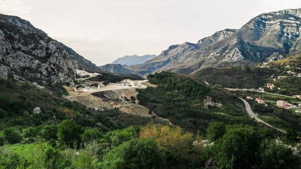 Mining industry in Budva. View of the mountains of Montenegro from the Haj Nehaj fortress. Production of building materials in Montenegro.Stationary concrete plant in Budva. Mining of rock - Foto, Bild