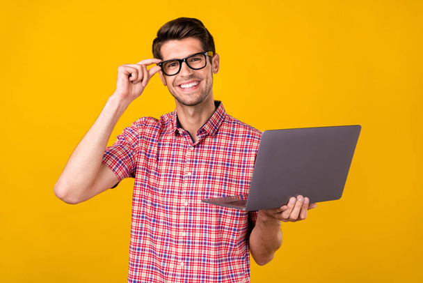 Photo of young business man happy positive smile work laptop programmer isolated over yellow color background. - Foto, imagen