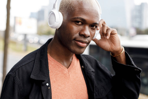 black afro man with headphones portrait outdoor. High quality photo - Valokuva, kuva