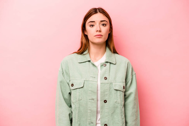 Young caucasian woman isolated on pink background sad, serious face, feeling miserable and displeased. - Photo, Image