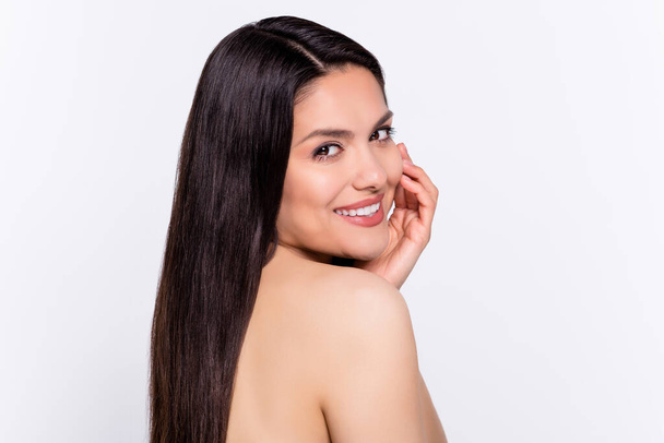 Photo portrait brunette woman smiling applying face lotion pampering isolated white color background. - Foto, Imagen