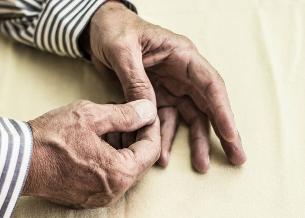 Elderly man has pain in fingers and hands - Photo, Image