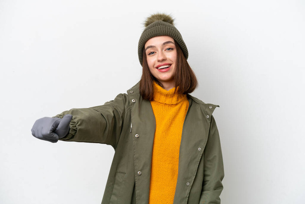 Young Ukrainian woman wearing winter jacket isolated on white background giving a thumbs up gesture - Photo, Image