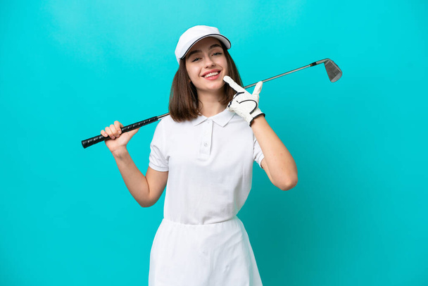 Young Ukrainian golfer player woman isolated on blue background giving a thumbs up gesture - Фото, зображення