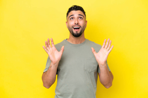 Young Arab handsome man isolated on yellow background stressed overwhelmed - Fotoğraf, Görsel