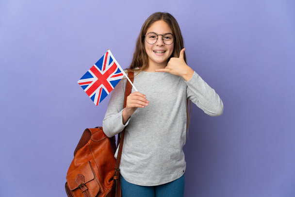 Child holding an United Kingdom flag over isolated background making phone gesture. Call me back sign - Valokuva, kuva