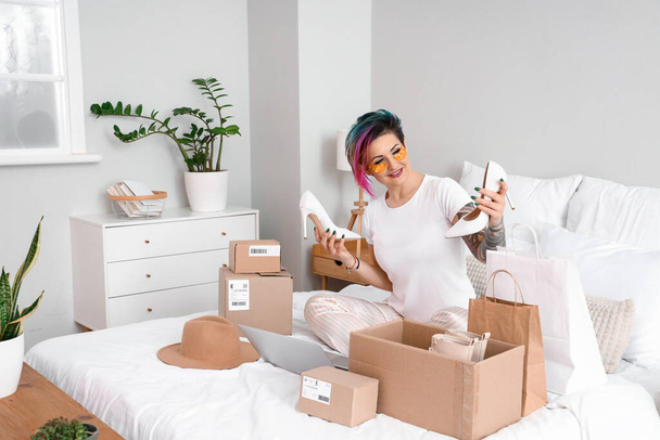 Bella donna con i tacchi nuovi in camera da letto. Shopping online - Foto, immagini