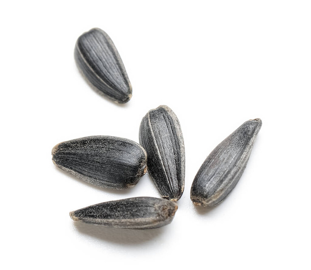 Unpeeled sunflower seeds on white background - Photo, Image