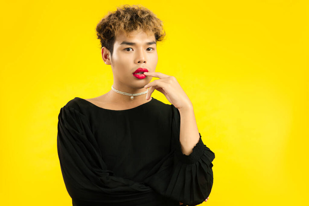 asian gay posing isolated yellow color background. lgbtq and lgbtq+ pride concepts - Fotó, kép