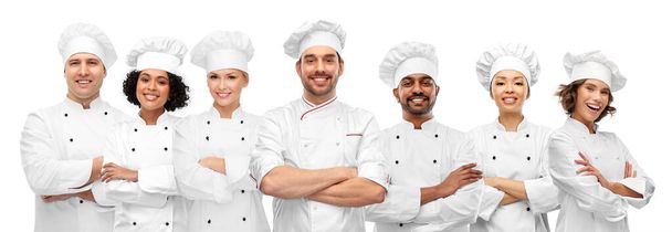 cooking, culinary and profession concept - international team of smiling chefs with crossed arms - Φωτογραφία, εικόνα