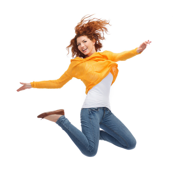 smiling young woman jumping in air - Photo, image