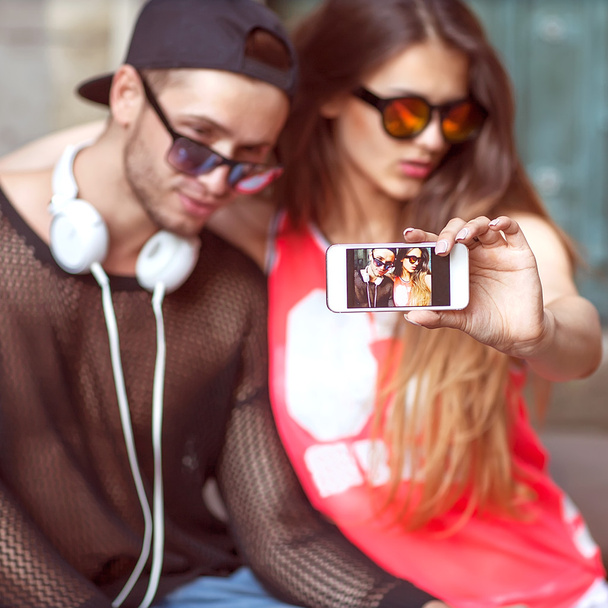 Young fashion couple taking selfie in the city - Фото, изображение