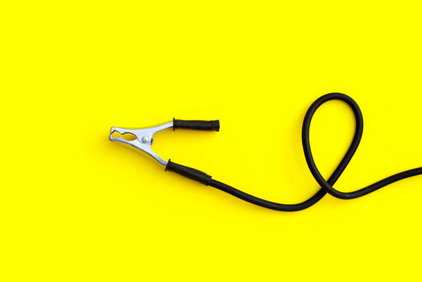 Welding ground clamp on yellow background. - Fotografie, Obrázek