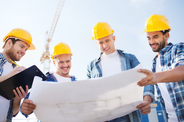 group of builders with tablet pc and blueprint - Foto, Bild