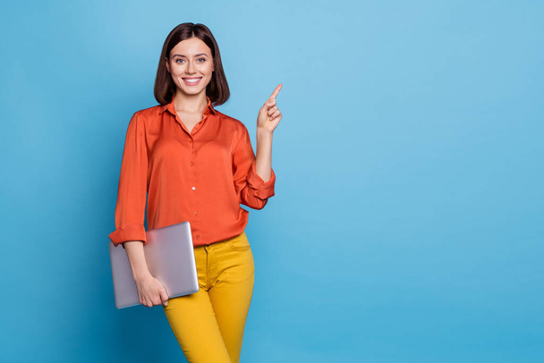 Portrait of attractive cheerful skilled girl holding laptop showing copy empty space ad isolated over bright blue color background. - Φωτογραφία, εικόνα
