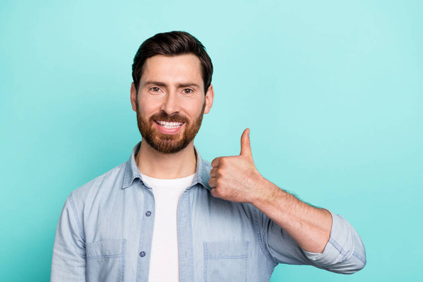 Photo of positive guy promoter make thumb-up symbol alright offer advertisement isolated on cyan color background. - Zdjęcie, obraz