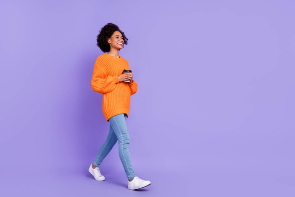 Full length body size view of attractive cheerful girl strolling drinking latte copy space isolated on bright purple violet color background. - 写真・画像