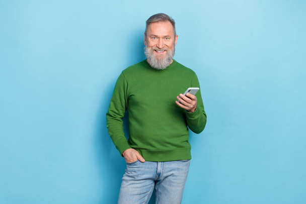 Photo of middle aged man blogger use gadget technology search network news isolated blue color background. - Fotoğraf, Görsel
