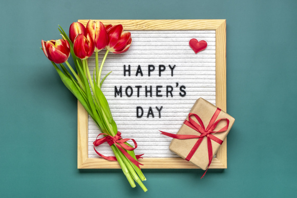 Plstěná deska s textem Šťastný Den matek, červené tulipány kytice na zeleném pozadí pozdrav dovolená karta Flat lay Top view. - Fotografie, Obrázek