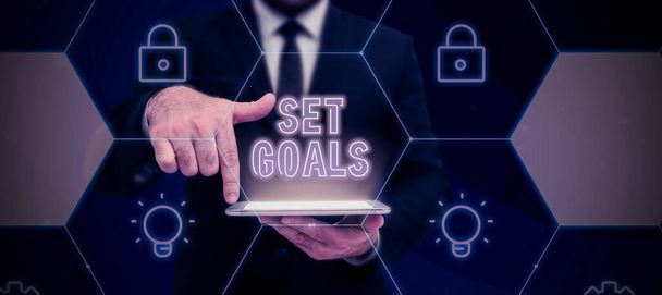 Text showing inspiration Set Goals, Business concept Defining or achieving something in the future based on plan Lady in suit holding pen symbolizing successful teamwork accomplishments. - Photo, Image