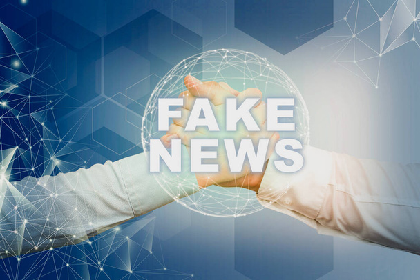Text caption presenting Fake News, Business idea Giving information to showing that is not true by the media Hands shaking symbolizing globalization presenting teamwork. - Photo, Image