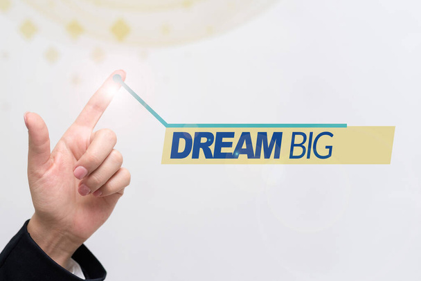 Text sign showing Dream Big, Business approach To think of something high value that you want to achieve Palm Carrying Money For Mortgage Plans For Home And Office. - Photo, Image