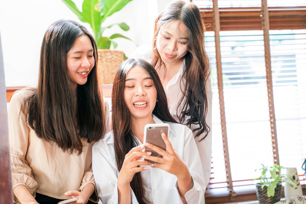 Beautiful asian women with friend use smartphone online shopping in house happy together - Photo, image