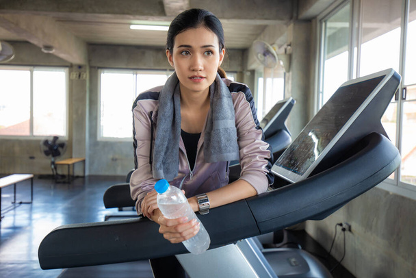 Sport women leisure and drink water after burn running on treadmill Women in gym - Photo, Image