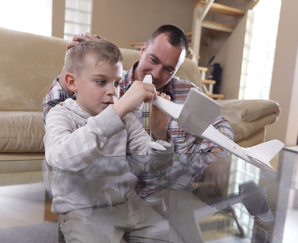 Father and son assembling airplane toy - Foto, Imagem