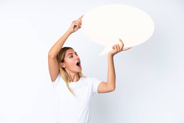 Blonde Uruguayan girl isolated on white background holding an empty speech bubble - Foto, imagen