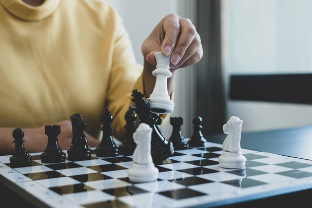 Hand of businesswoman moving, chess in competition shows leadership, followers, and business success strategies. - Photo, image