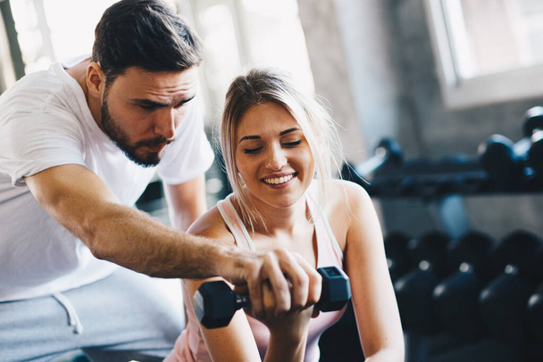 Sporty couple make weight lifting together in loft gym healthy lifestyle - Photo, Image