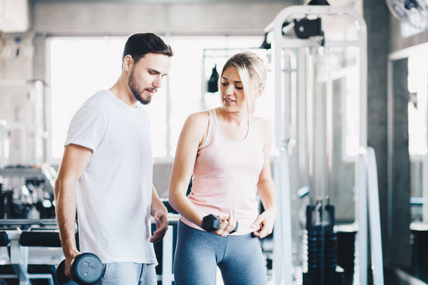 Sporty couple make weight lifting together in loft gym healthy lifestyle - Photo, Image