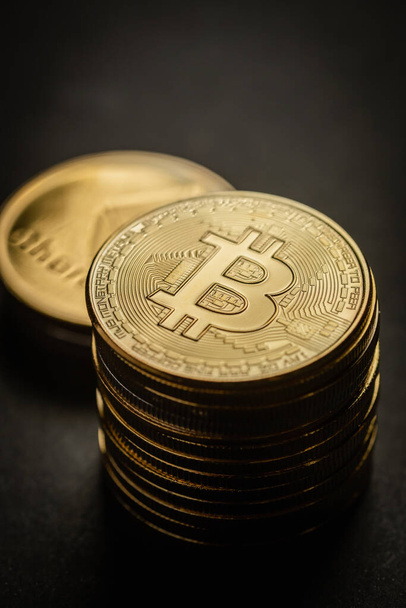 Close up shot of stacks of golden Bitcoin digital cryptocurrency. - Zdjęcie, obraz