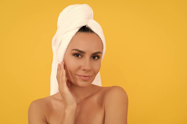 smiling young woman with towel after shower on yellow background. - Photo, Image