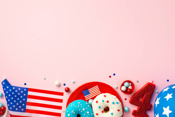 USA Independence Day concept. Top view photo of number 4 candle national flag paper molds with candies plate with glazed donuts balloon and confetti on isolated pastel pink background with empty space - Photo, Image