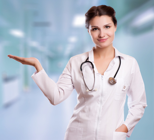 Beautiful successful female doctor holding something on her hands - Foto, afbeelding