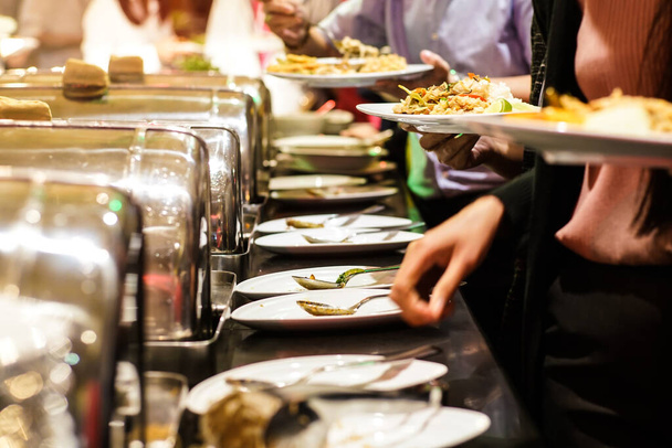 People hand grab buffet food serve in hotel restaurant business food and drink - Fotografie, Obrázek