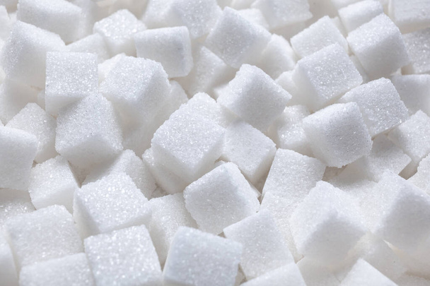 Rafinated sugar. Textured white background from sugar cubes. Light back. - Photo, Image